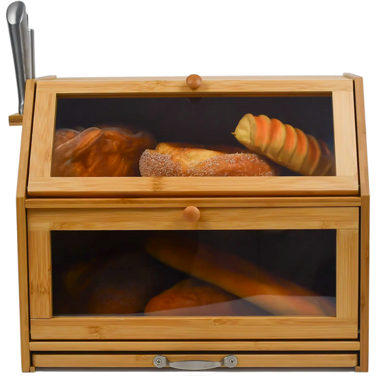 A bamboo bread bin with two compartments and a sliding chopping board, featuring a knife holder. The bread bin has air holes at the back and is displayed with various baked goods inside.