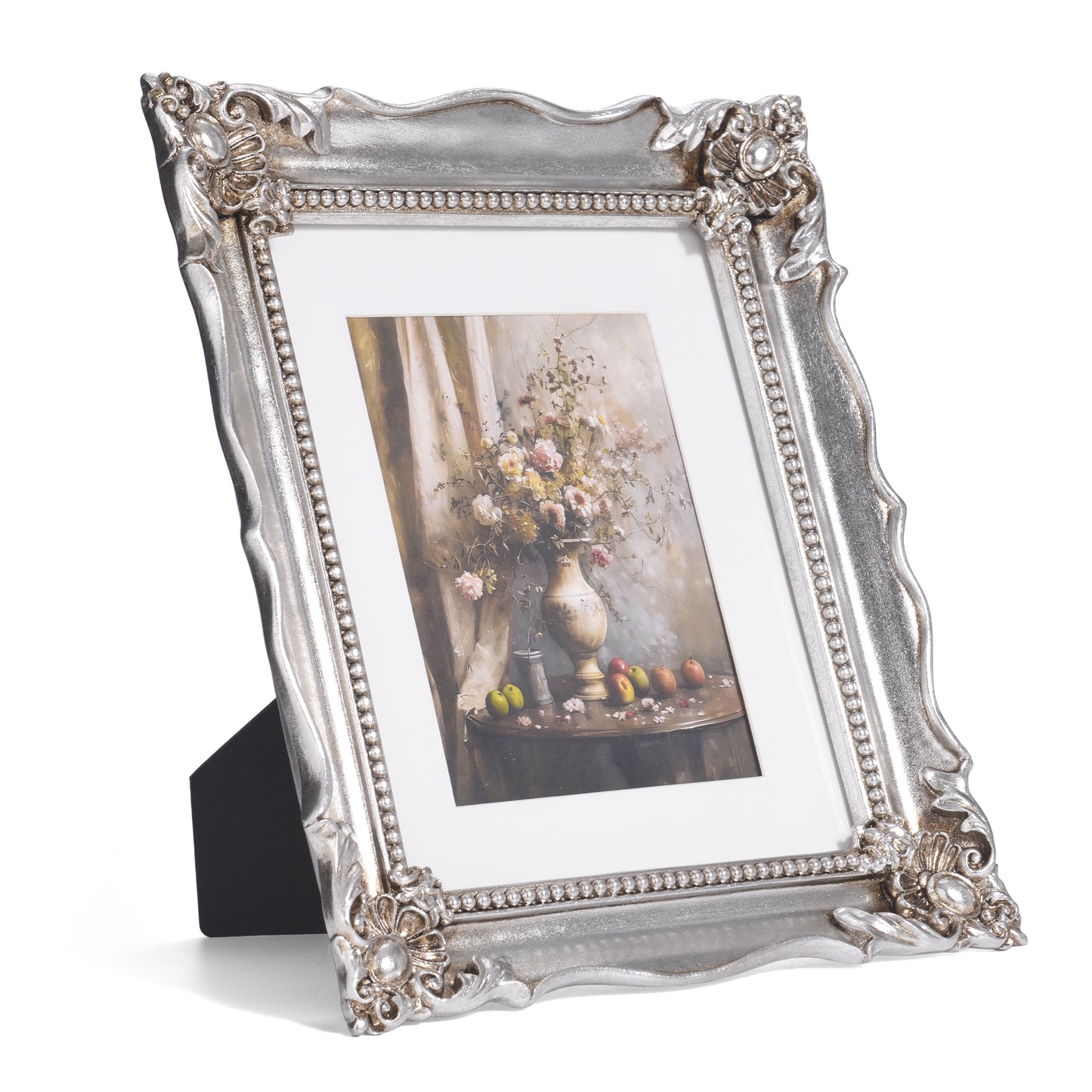 Silver decorative picture frame with a floral arrangement photo inside on a white background