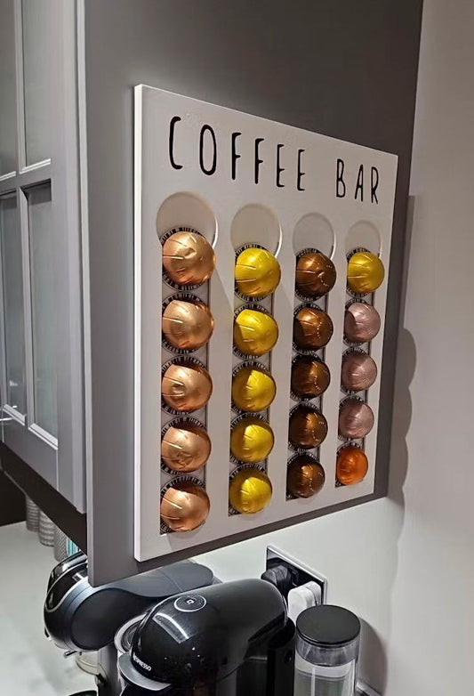 Decorative wall art with coffee pod designs and 'COFFEE BAR' text in a kitchen setting.