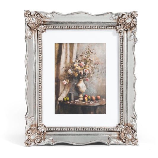 Decorative silver frame with a floral still life painting inside