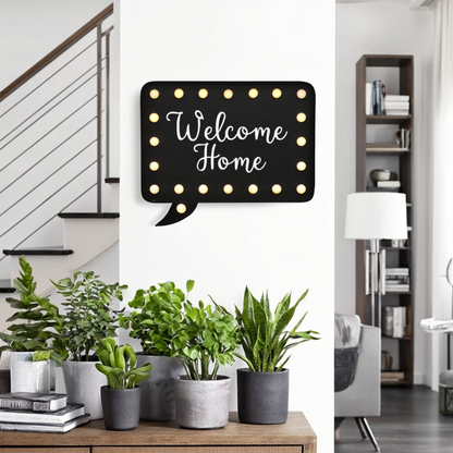 Decorative sign with 'Welcome Home' text in a modern living room setting.